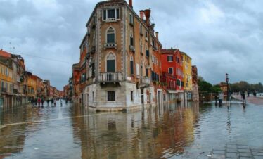 The architecture of Via Garibaldi shines during a rainy day.