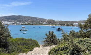 Pollonia's blue water framed by greenery.