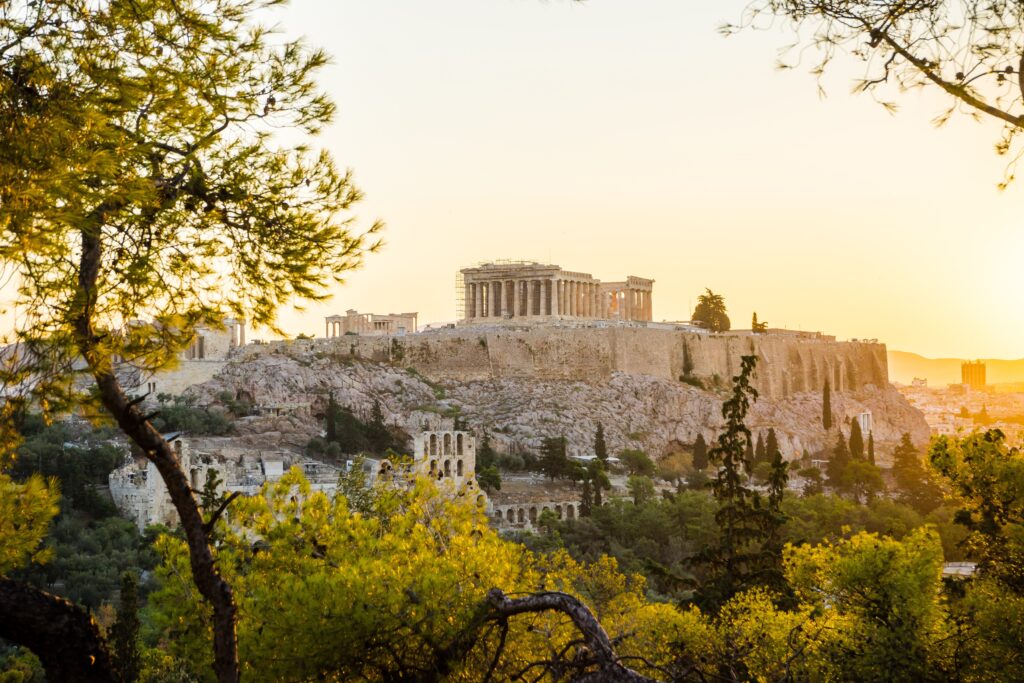 Beautiful Acropolis perched above the city, framed by the green of trees.