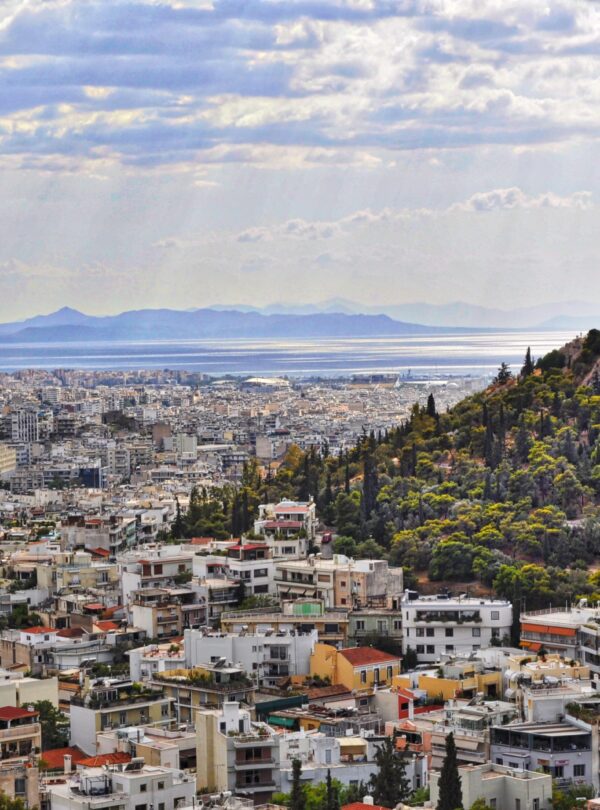 An Athens cityscape with the sea in the background.
