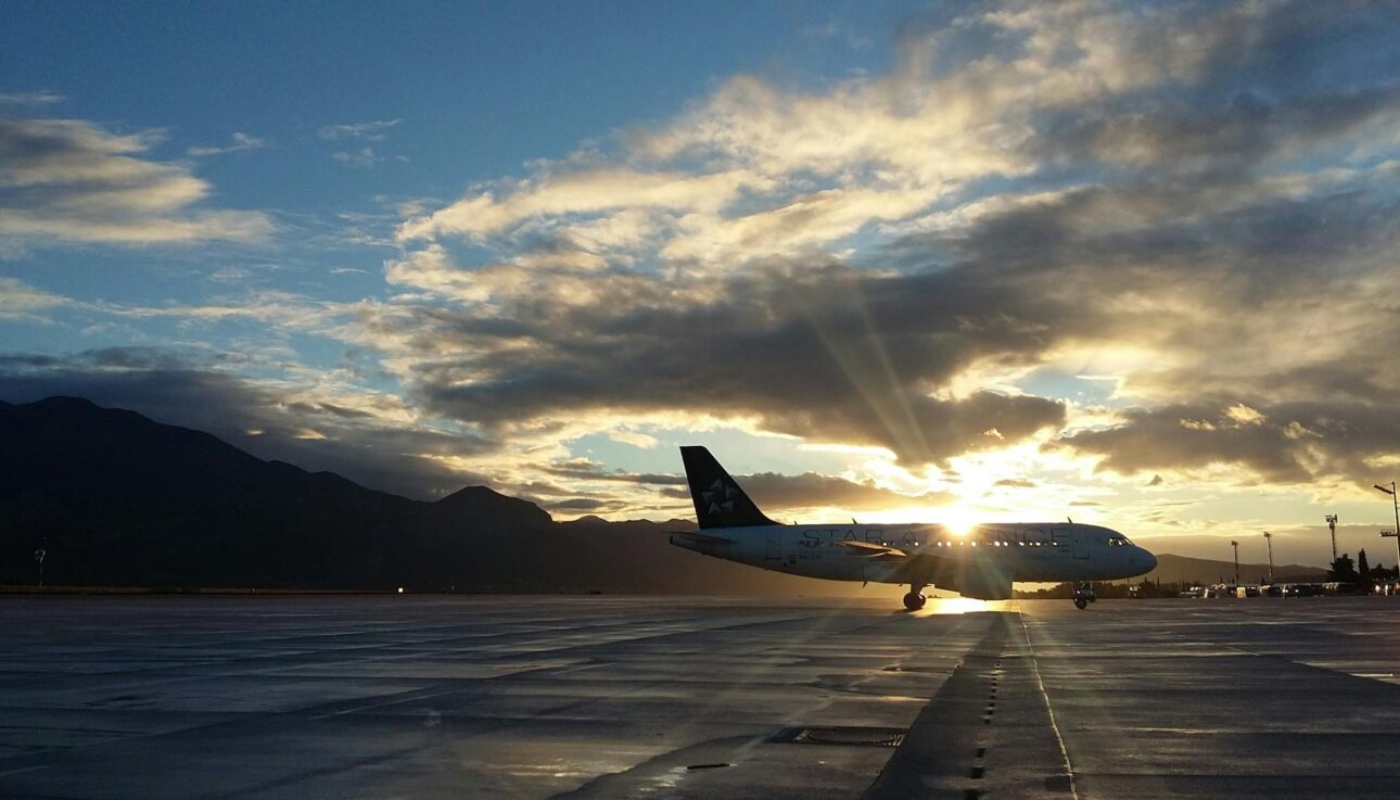 plane with sunlight shining behind the clouds