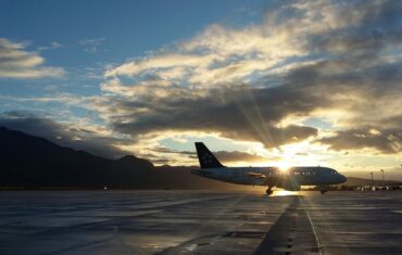 plane with sunlight shining behind the clouds