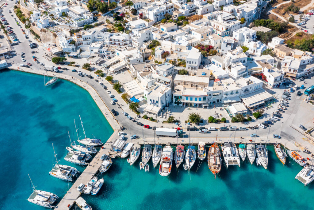 Adamantas, the port town, seen with the white buildings clashing with the blue water.