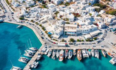 Adamantas, the port town, seen with the white buildings clashing with the blue water.